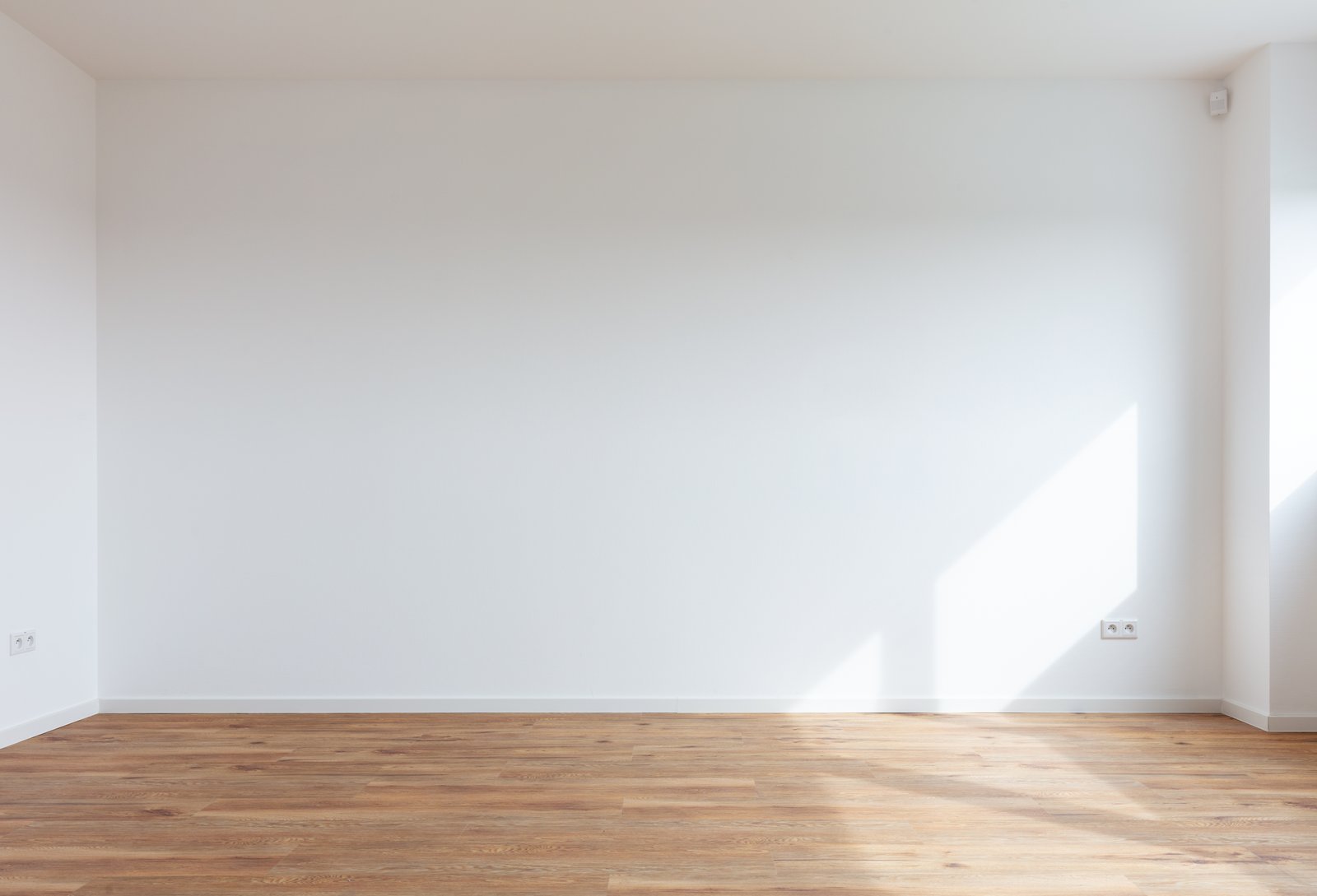 An example room with white walls and a wood floor.